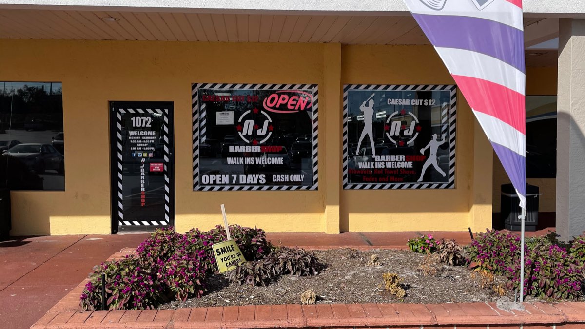 NJ Barbershop storefront with barber pole in Casselberry, Florida