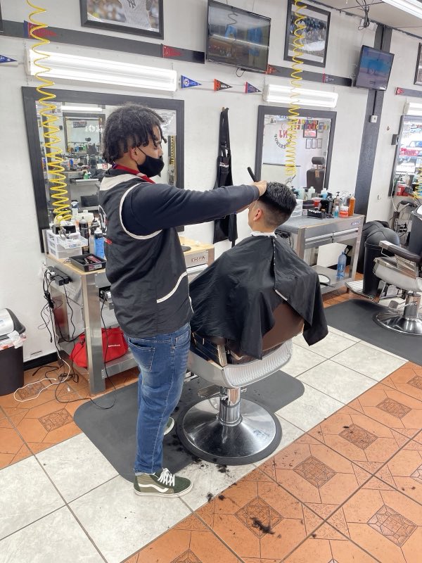 Barber giving a fresh cut in the chair at NJ Barbershop