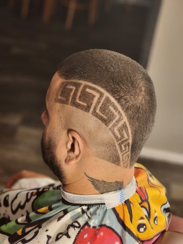 Detailed Greek-key hair design carved into a fresh fade